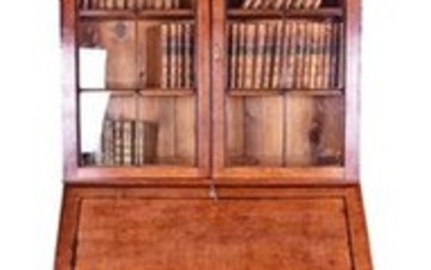 A George III oak bureau bookcase with arched vitrine to the top, the fall front opening to reveal a fitted interior with...