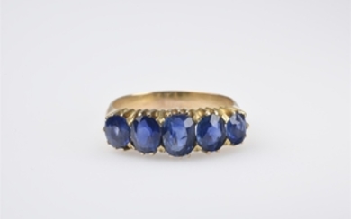 A 14k red gold and sapphire ring