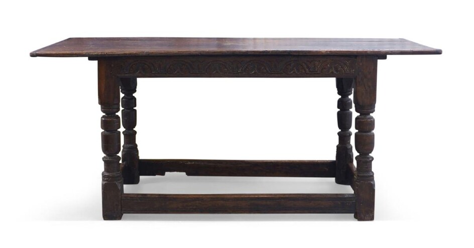A 17th century and later oak refectory table, the plank top raised on turned legs and block feet, joined by stretchers, 78cm high, 167cm wide, 75cm deep