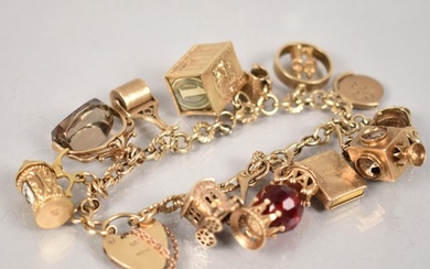 A 9ct Gold Charm Bracelet, 12 Gold Metal Charms, Most Stampe...