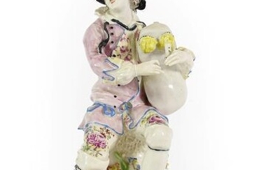 A Bow Porcelain Figure of a Bagpiper, circa 1765, seated...