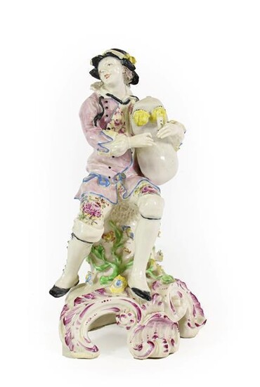 A Bow Porcelain Figure of a Bagpiper, circa 1765, seated...