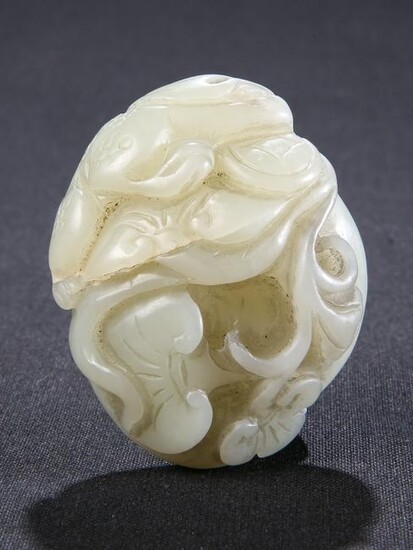 A CHINESE CELADON JADE CARVING, the pebble carved with