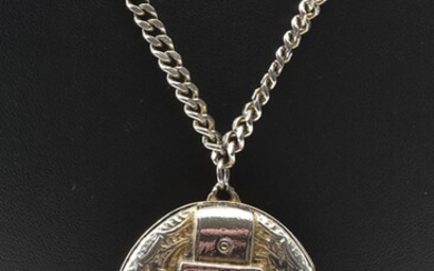 A CONTINENTAL SILVER OVAL HINGED LOCKET WITH BUCKLE MOTIF AND CHAIN