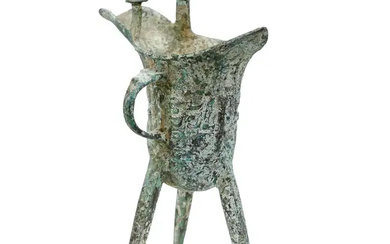 A Chinese Shang-style bronze tripod wine pouring vessel, jue 20th century With...