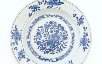 A Chinese blue and white plate decorated with flowers and fo...
