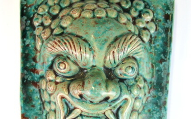 A Chinese glazed porcelain door guardian, 17 x 21 x 9cm.