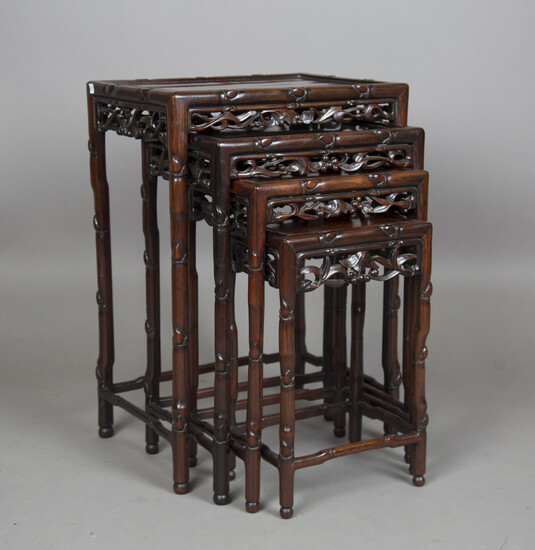 A Chinese hardwood quartetto nest of occasional tables, late Qing dynasty, each rectangular panelled
