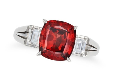 A GARNET AND DIAMOND THREE STONE RING set with a cushion cut garnet of 2.35 carats accented on ea...