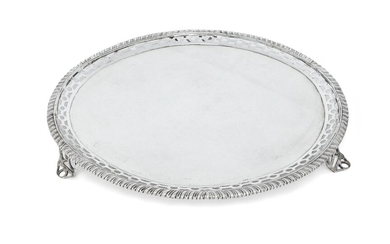 A George III Scottish silver salver, Edinburgh, 1773, Patrick Robertson, designed with pierced border and gadrooned edge, the base engraved with armorial (rubbed) and raised on three openwork bracket feet, 32.5cm dia., approx. weight 37.5oz