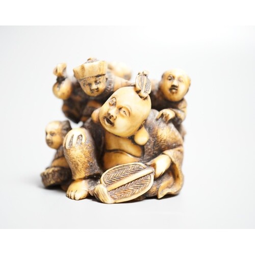 A Japanese ivory netsuke of Hotei with three boys, Meiji per...