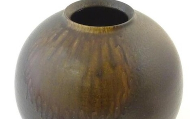 A Japanese vase of globular form with a drip glaze.
