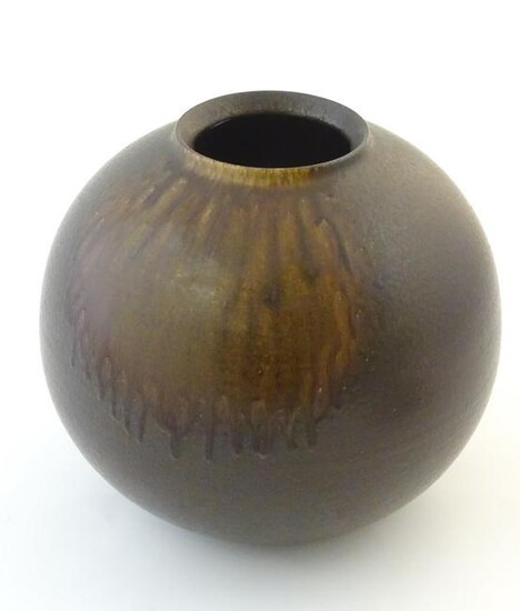 A Japanese vase of globular form with a drip glaze.