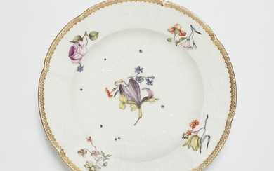 A Meissen porcelain plate from a dinner service with woodcut style flowers