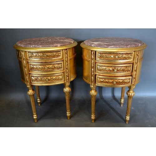 A Pair of French Gilded Oval Chests, the variegated marble t...