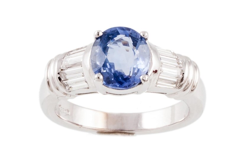 A SAPPHIRE AND DIAMOND RING, with one oval cut sapphire of 2...
