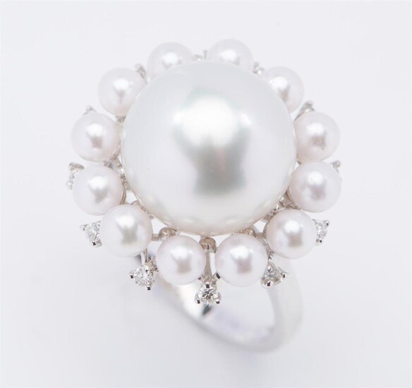 A SOUTH SEA PEARL, SEED PEARL AND DIAMOND RING - Featuring a round pearl of silver white hues measuring 12.4mm, within a border of s...