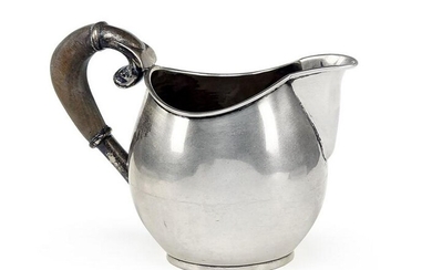 A Sanborns Mexican Sterling Silver Milk Pitcher.