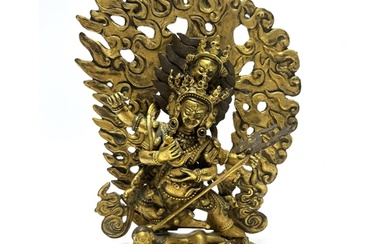 A Sino Tibetan gilt bronze figure of Mahakala