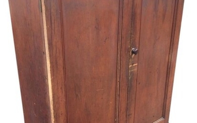 A Victorian pine cupboard with panelled doors enclosing shelves,...