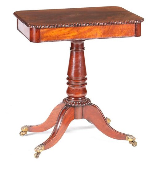 A WILLIAM IV FLAMED MAHOGANY LAMP TABLE with gadrooned