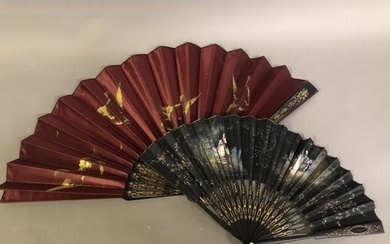 A black wood fan, carved and gilded, early 20th c, mounted w...