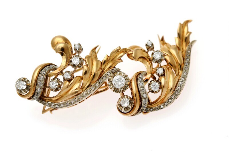 NOT SOLD. A diamond brooch set with numerous diamonds, mounted in 18k gold and white...