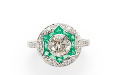 A diamond, emerald and eighteen karat white gold ring