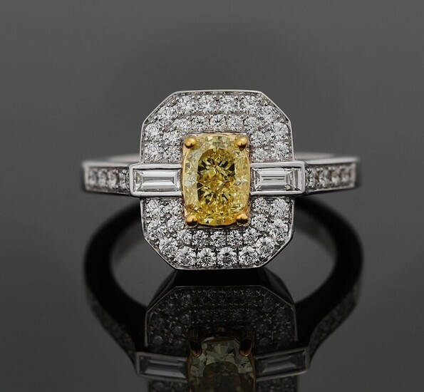 NOT SOLD. A diamond ring set with a Fancy Yellow diamond weighing app. 1.05 ct....