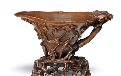 A fine Chinese carved rhinoceros libation cup. Qing, 17–18th century. Weight 206 g. L. 17 cm. H. 8,5 cm.