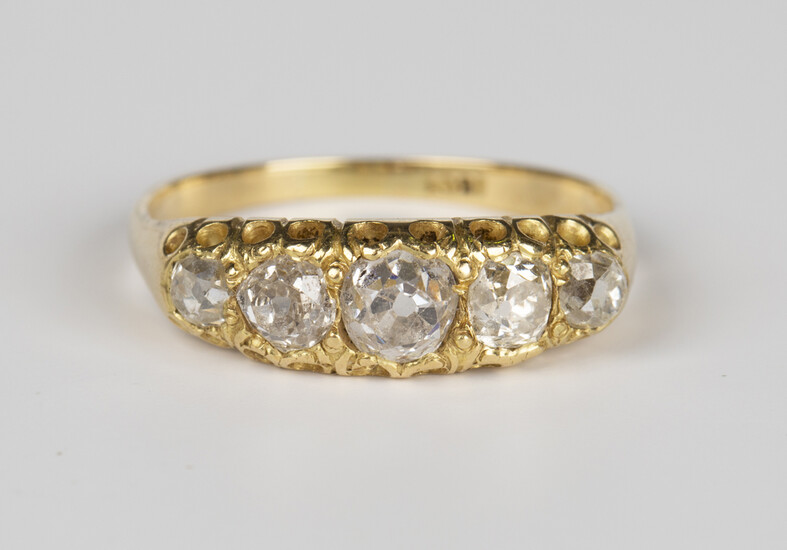 A gold and diamond five stone ring, mounted with a row of graduated cushion cut diamonds, the mount
