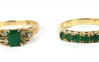 A gold emerald and diamond ring