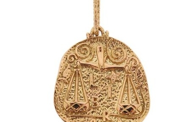 A gold medallion zodiac pendant, the asymmetrical oval medallion depicting...
