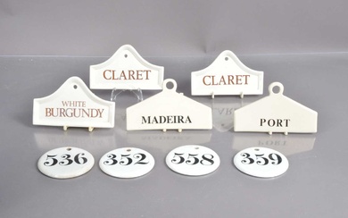 A group of nine porcelain and pottery wine bin labels