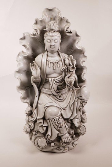 A large Chinese blanc de chine figure of Quan Yin seated wit...