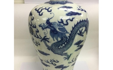 A large blue and white baluster vase decorated with a dragon...