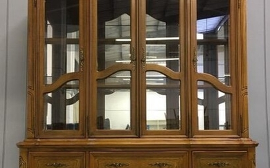A large, walnut-veneered display cabinet. Glazed/shelved cupboard over five...