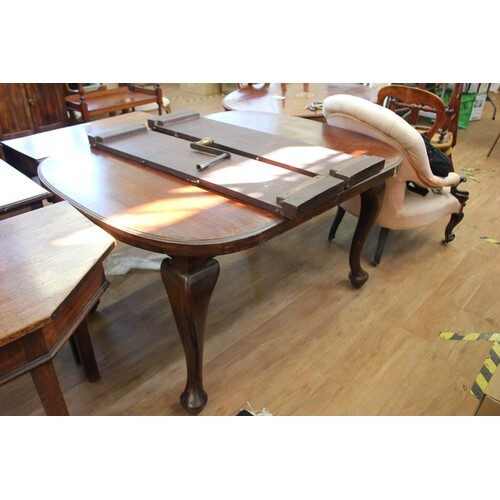 A late Victorian mahogany wind-out dining table, on cabriole...