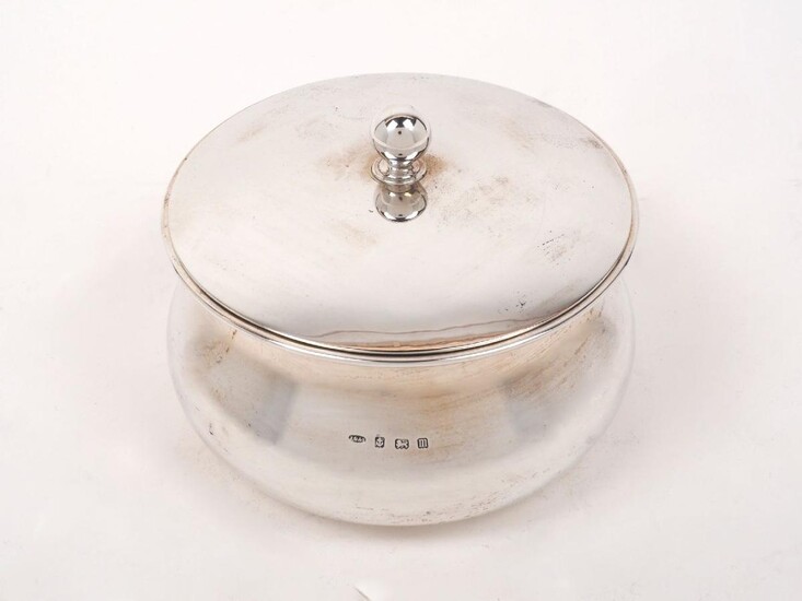 A lidded circular silver dish, Birmingham, c.1911, John Grinsell & Sons, of round waisted form with globular finial to pull-off lid, 8cm high, approx. weight 12.8oz