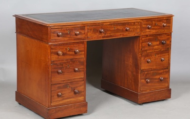 A mid-Victorian mahogany twin-pedestal desk, the moulded top inset with gilt-tooled black leather ab