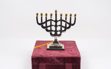 A modern Fred Hollings Jewish menorah, of typical form, with...