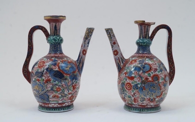 A near pair of Chinese porcelain ewers, 19th century, lacking covers, with knopped necks, curved handle and straight spout, decorated with foliage to the body in red blue and green with gilt highlights, iron red mark to the underside, 21.5cm and...