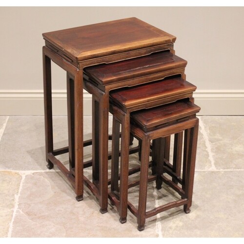 A nest of four Chinese hard wood quartetto tables, each tabl...