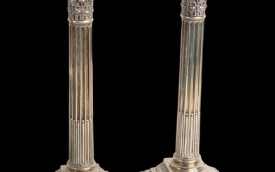 A pair of Edwardian silver Corinthian column table candlesti...