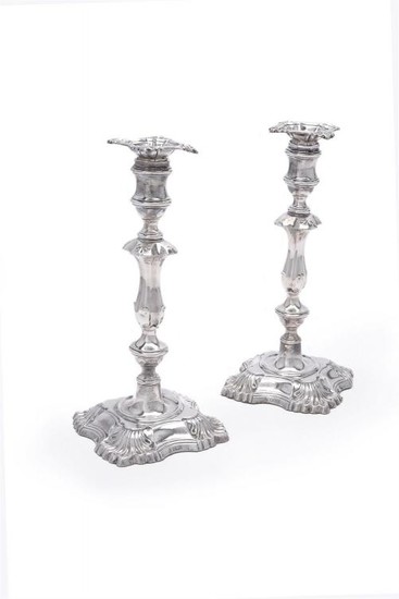 A pair of Edwardian silver shaped square candlesticks by William Hutton & Sons