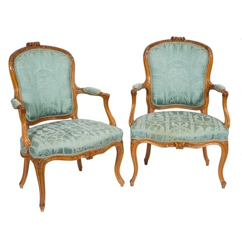 A pair of French carved beech wood fauteuils in the Louis XV...