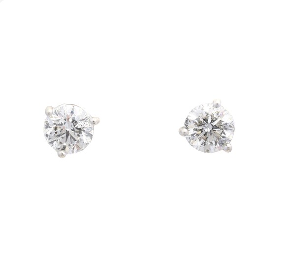 A pair of brilliant cut diamond stud earrings