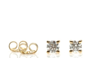 A pair of diamond earstuds, each set with a brilliant-cut diamond weighing...