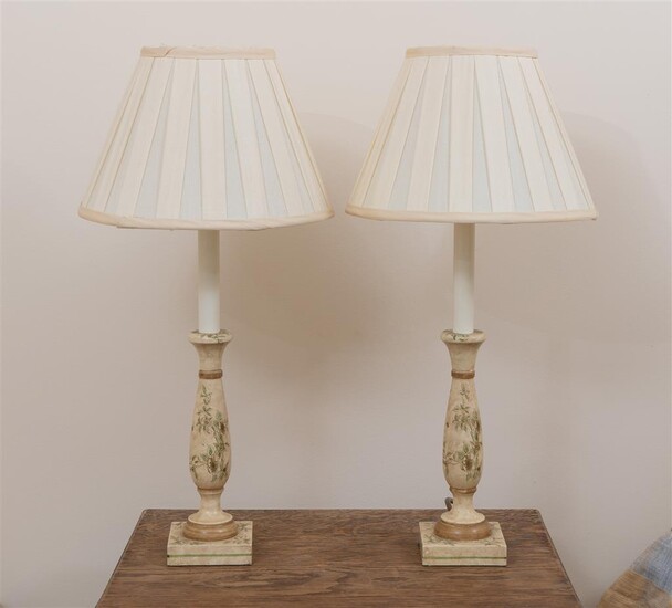 A pair of small lamps with cream shades and painted...