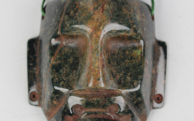 A pre-Columbian Olmec style carved spinach green jade hollowed-out mask, probably 900-450 BC, height